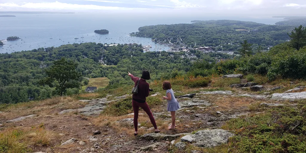 My wife and stepdaughter standing on top of Mount Battie in Camden, ME overlooking the Camden harbor. Photo is shot from behind, so their faces aren't visible.