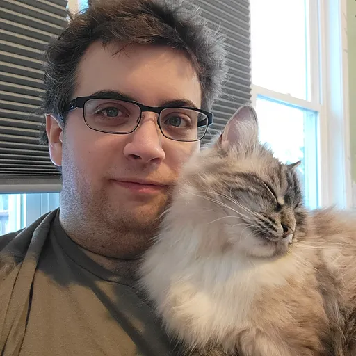 Headshot of me holding my sleeping cat